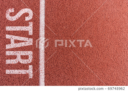 White painted line on tartan ground track in a athleticism and sports field. White painted line on tartan ground track in a athleticism and sports field. 69748962