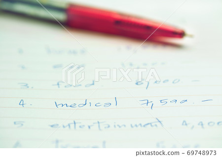 pen on white sheet with month budget for medical cost or to the treatment of illness 69748973