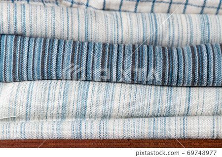 close-up of white and blue pattern cotton fabric texture on shelf in natural fabric shop close-up of white and blue pattern cotton fabric texture on shelf in natural fabric shop 69748977