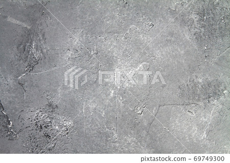 Concrete dark gray background with scuffs and black splashes. Textured wall texture in the grunge style. Concrete dark gray background with scuffs and black splashes. Textured wall texture in the grunge style. 69749300