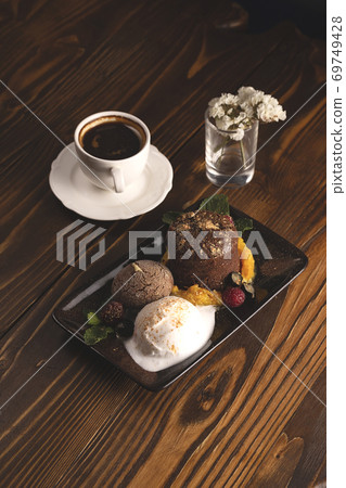 Nicely served chocolate fondant with ice cream. Food styling Nicely served chocolate fondant with ice cream. Food styling 69749428