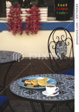 Cheese pancakes in a restaurant with a beautiful presentation Cheese pancakes in a restaurant with a beautiful presentation 69749484