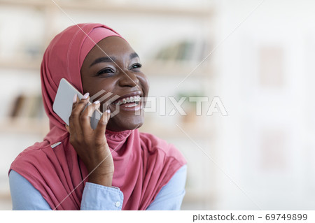 Mobile Communication. Cheerful Black Muslim Woman Talking On Cellphone, Closeup Shot Mobile Communication. Cheerful Black Muslim Woman Talking On Cellphone, Closeup Shot 69749899