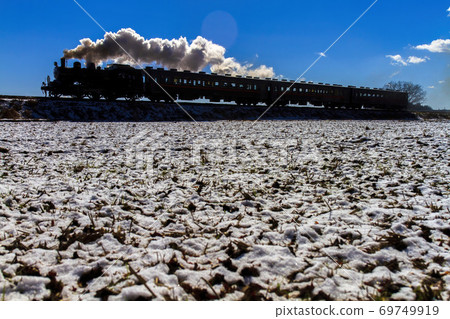 Blue sky and SL silhouette after snowfall Moka Tetsudo 69749919