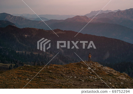 Young male hipster in the mountains in autumn Young male hipster in the mountains in autumn 69752294