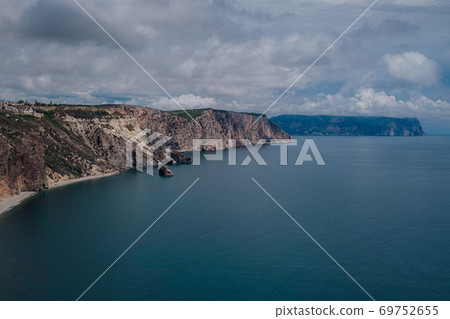 Beautiful view from the cliff on the blue sea. Beautiful view from the cliff on the blue sea. 69752655