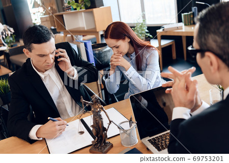 Upset woman sits next to man talking on phone. Upset woman sits next to man talking on phone. 69753201