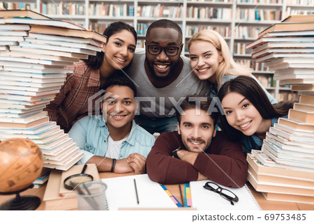 Cheerful students sitting together in the library. 69753485