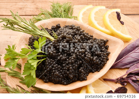 Black caviar with fresh herbs 69754316