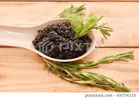 Black caviar with fresh herbs 69754318
