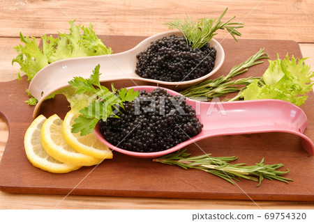 Black caviar with fresh herbs Black caviar with fresh herbs 69754320