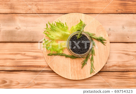 Black caviar with fresh herbs Black caviar with fresh herbs 69754323