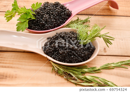 Black caviar with fresh herbs Black caviar with fresh herbs 69754324