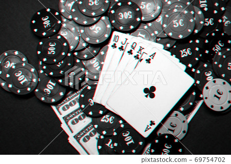 Winning combination of cards in casino poker. Royal flush, a bunch of chips and money dollars 69754702