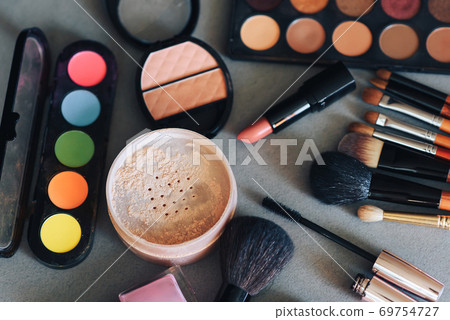 women's cosmetics for beauty and skin care on the table. Makeup brushes, eye shadow palette, lipstick, powder, mascara 69754727