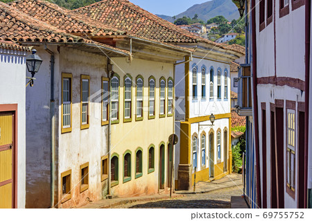 Quiet street with old colorful houses in colonial architecture, cobblestones and lanterns Quiet street with old colorful houses in colonial architecture, cobblestones and lanterns 69755752
