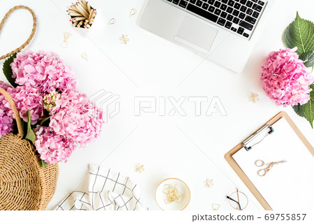 Workspace with clipboard, laptop, bouquet hydrangea, accessories on white background. Stylized women's desk. Flat lay. Top view. Workspace with clipboard, laptop, bouquet hydrangea, accessories on white background. Stylized women's desk. Flat lay. Top view. 69755857