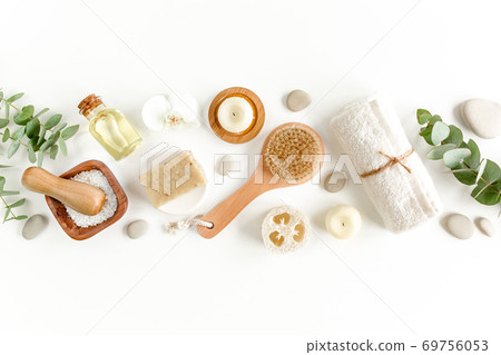 Spa Background. Natural, Organic spa cosmetics products, eco friendly bathroom accessories, eucalyptus leaves. Skincare concept on white background. Spa Background. Natural, Organic spa cosmetics products, eco friendly bathroom accessories, eucalyptus leaves. Skincare concept on white background. 69756053