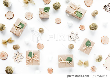 christmas toys and craft boxes. creative arrangement frame of craft boxes and green branches eucalyptus on white background. flat lay, top view christmas toys and craft boxes. creative arrangement frame of craft boxes and green branches eucalyptus on white background. flat lay, top view 69756054