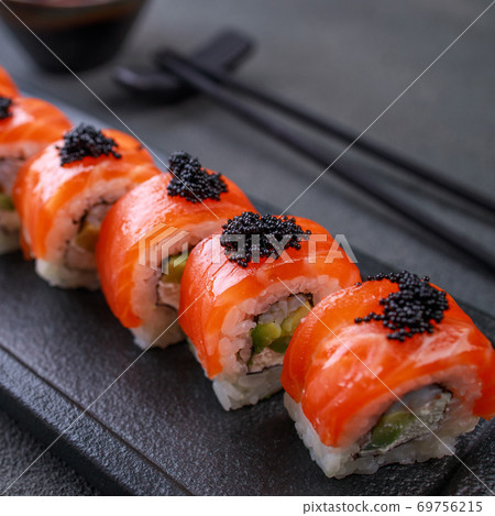 Seafood delicatessen salmon sushi rolls on plate 69756215