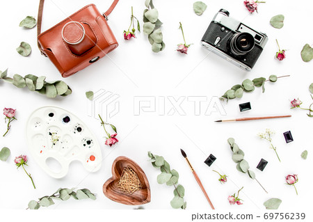 desk, retro camera, watercolor. brushes, leaves eucalyptus on white background. magazines, social media. Home office workspace. flat lay, top view desk, retro camera, watercolor. brushes, leaves eucalyptus on white background. magazines, social media. Home office workspace. flat lay, top view 69756239