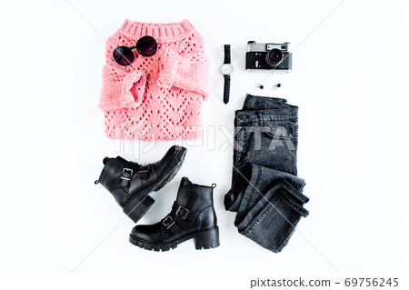 Women fashion clothes and accessories on white background top view. Flat lay female style look with warm sweater, jeans, boot, glasses. Top view. 69756245