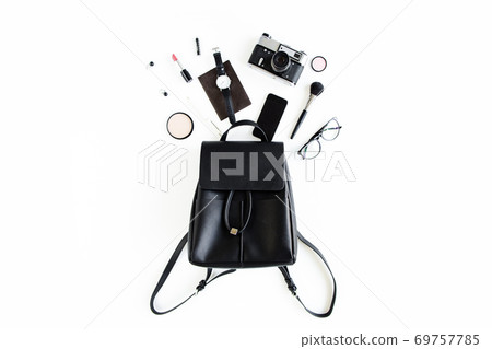 Women's beige backpack with fashion accessories on white background top view. Flat lay female style look. Top view. 69757785