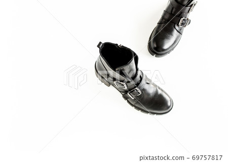 Black female boots on white background. Flat lay, top view minimal background. Fashion blog or magazine concept. Black female boots on white background. Flat lay, top view minimal background. Fashion blog or magazine concept. 69757817