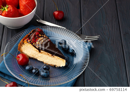 Vanilla cheesecake with chocolate top and berries Vanilla cheesecake with chocolate top and berries 69758114