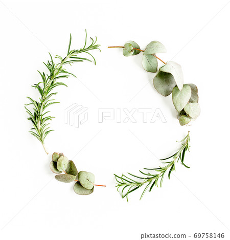 Round wreath frame made of mix of herbs, green branches, leaves eucalyptus, rosemary and plants collection on white background. Flat lay. Top view. 69758146