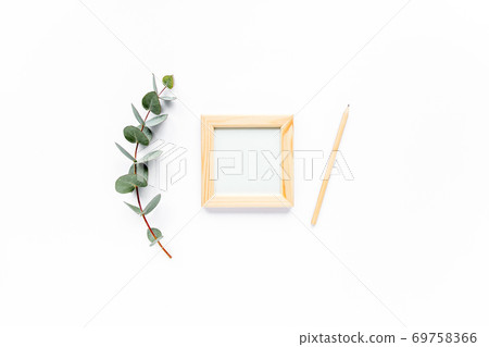 frame, pencil, pen, green leaves eucalyptus on white background. flat lay, top view frame, pencil, pen, green leaves eucalyptus on white background. flat lay, top view 69758366