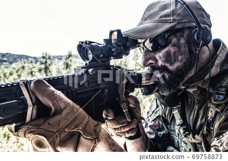 Modern war combatant, soldier aiming service rifle 69758873