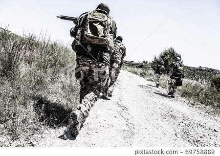 Army soldiers running on road in abandoned area Army soldiers running on road in abandoned area 69758889