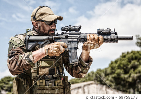 Private military company mercenary with gun 69759178