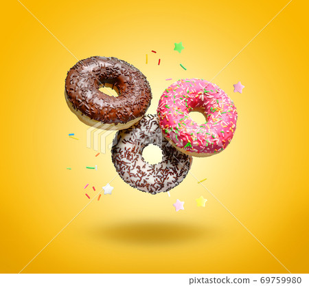 Flying donuts on yellow background. Flying donuts on yellow background. 69759980