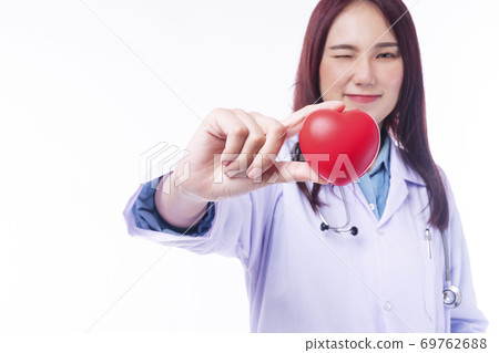Selective focus hand of friendly doctor woman wear uniform with stethoscope hold red heart, 69762688
