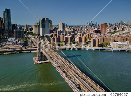 Flying backward view of across Brooklyn Bridge through the East river to Manhattan district Flying backward view of across Brooklyn Bridge through the East river to Manhattan district 69764067
