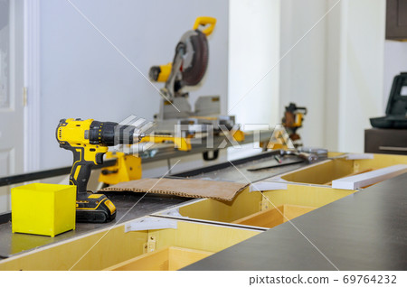 Wooden furniture production of professional instrument tools screwdriver on blurred background 69764232