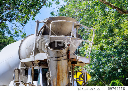 Cement truck mixer pouring fresh cement concrete Cement truck mixer pouring fresh cement concrete 69764358