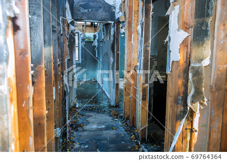 Completely burnt wooden house consequences of fire in California 69764364