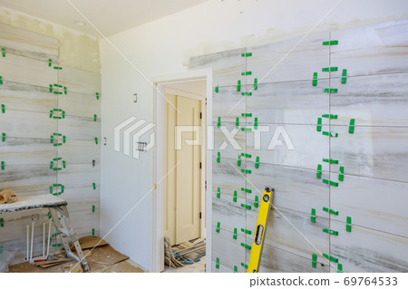 Bathroom construction laying floor and wall tile unfinished reconstruction Bathroom construction laying floor and wall tile unfinished reconstruction 69764533