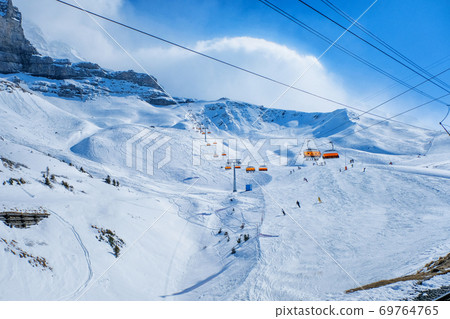 Panoramic view of ski chair lift in high mountains in Switzerland Panoramic view of ski chair lift in high mountains in Switzerland 69764765