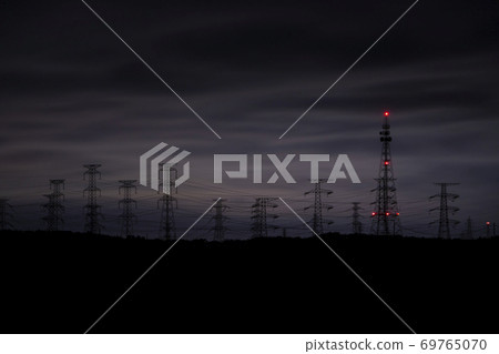 A group of steel towers floating in the darkness of the night 69765070