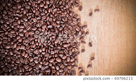 Roasted coffee beans on wooden background with copy space. Natural texture background. 69766213