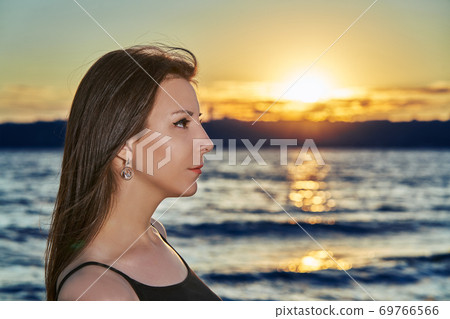 Portrait of a young brunette woman against the backdrop Portrait of a young brunette woman against the backdrop 69766566