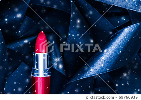 Red lipstick on blue silk and shiny glitter background, luxury make-up and beauty cosmetic Red lipstick on blue silk and shiny glitter background, luxury make-up and beauty cosmetic 69766939