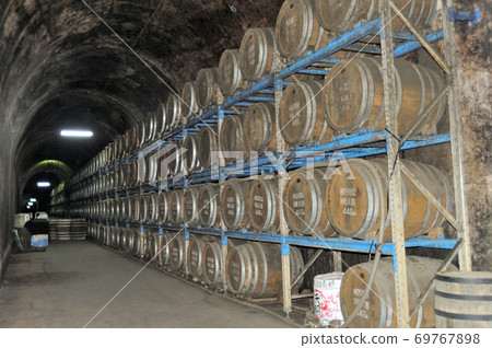 Scenery of shochu liquor being aged in the tunnel storage on the premises of the tunnel station in Takachiho-cho, Nishiusuki-gun, Miyazaki Prefecture. Scenery of shochu liquor being aged in the tunnel storage on the premises of the tunnel station in Takachiho-cho, Nishiusuki-gun, Miyazaki Prefecture. 69767898