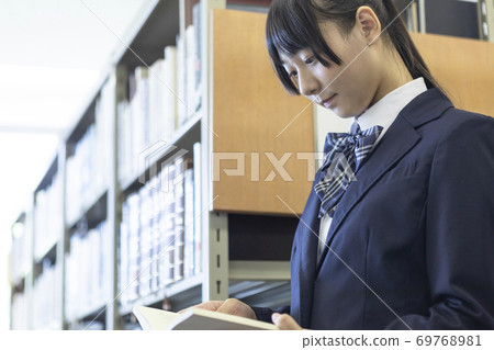 Schoolgirl in the library 69768981