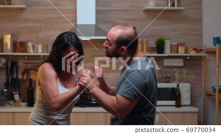 Drunk partner abusing woman Drunk partner abusing woman 69770034