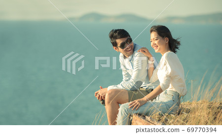 asian younger couples relaxing at sea side asian younger couples relaxing at sea side 69770394